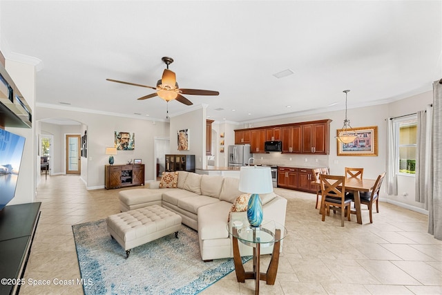 366 Gardendale Cir SE, Palm Bay, FL 32909 - living room with light tile patterned floors, baseboards, arched walkways, ceiling fan, and ornamental molding