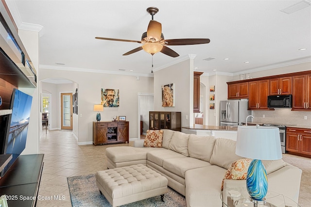 366 Gardendale Cir SE, Palm Bay, FL 32909 - living area with crown molding, a ceiling fan, light tile patterned floors, baseboards, and arched walkways