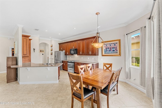 366 Gardendale Cir SE, Palm Bay, FL 32909 - dining area with baseboards, visible vents, crown molding, and arched walkways