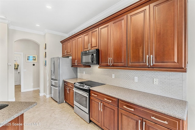 366 Gardendale Cir SE, Palm Bay, FL 32909 - kitchen featuring ornamental molding, brown cabinets, appliances with stainless steel finishes, arched walkways, and backsplash