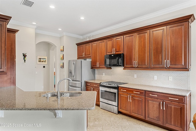 366 Gardendale Cir SE, Palm Bay, FL 32909 - kitchen with a sink, stone counters, arched walkways, visible vents, and appliances with stainless steel finishes