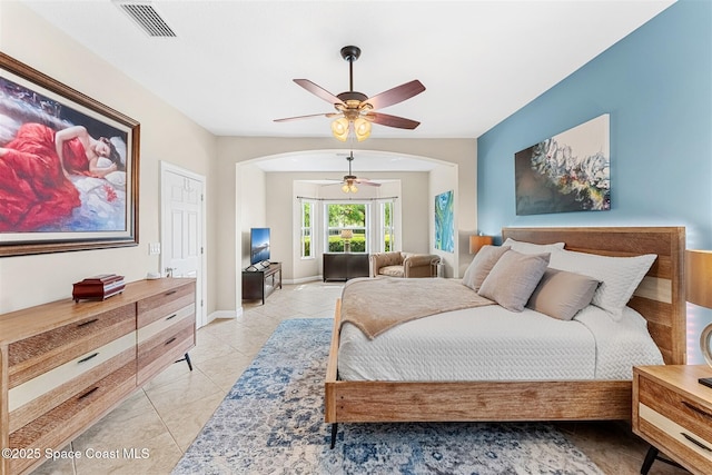 366 Gardendale Cir SE, Palm Bay, FL 32909 - bedroom with light tile patterned floors, baseboards, arched walkways, ceiling fan, and visible vents