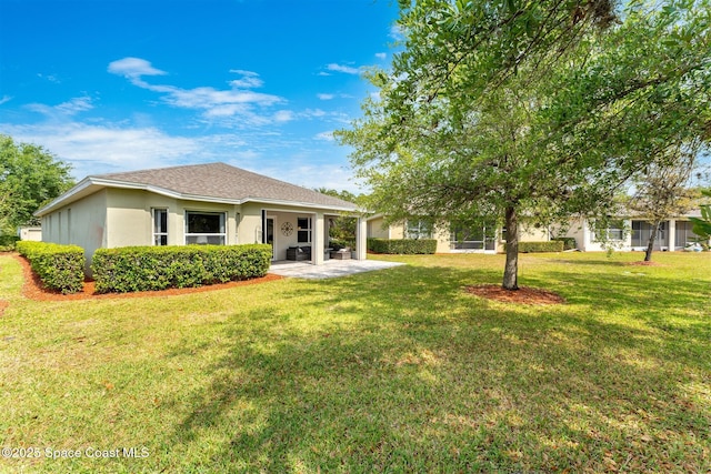 366 Gardendale Cir SE, Palm Bay, FL 32909 - back of house with a lawn, stucco siding, and a patio