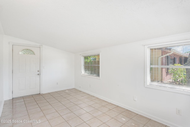 2880 Fountainhead Blvd, Melbourne, FL 32935 - foyer entrance with lofted ceiling, baseboards, and light tile patterned flooring