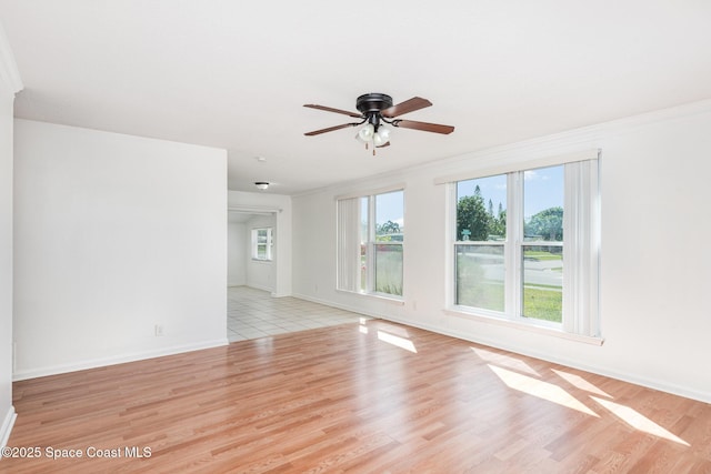 2880 Fountainhead Blvd, Melbourne, FL 32935 - spare room with healthy amount of natural light, a ceiling fan, light wood-style floors, and crown molding