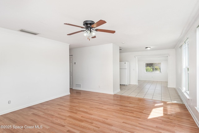 2880 Fountainhead Blvd, Melbourne, FL 32935 - spare room featuring a ceiling fan, light wood-style flooring, baseboards, and ornamental molding