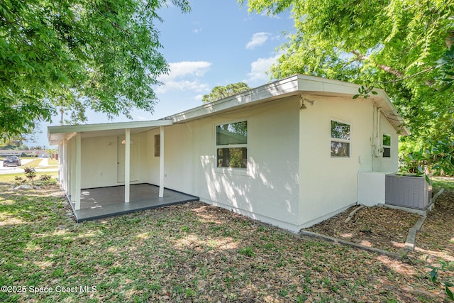 2880 Fountainhead Blvd, Melbourne, FL 32935 - back of house with a patio area, stucco siding, and central AC unit