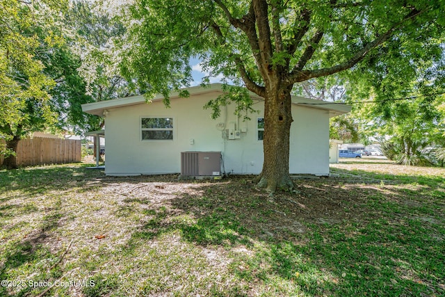 2880 Fountainhead Blvd, Melbourne, FL 32935 - rear view of house with central air condition unit and fence