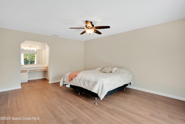 bedroom with light wood finished floors, visible vents, a ceiling fan, and baseboards