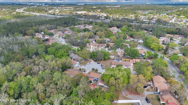 drone / aerial view with a residential view and a wooded view