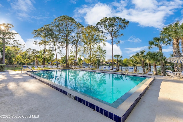 community pool featuring a patio and fence