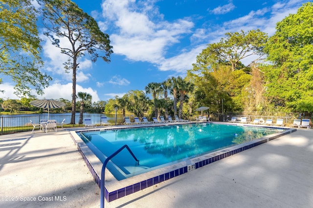 community pool featuring a patio and fence