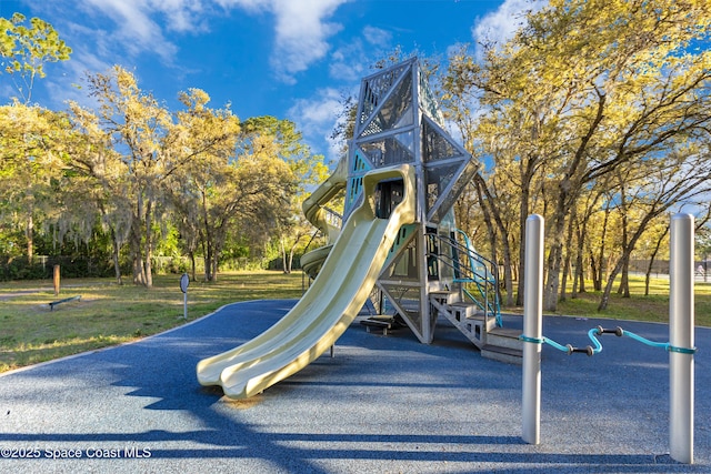 communal playground featuring a lawn