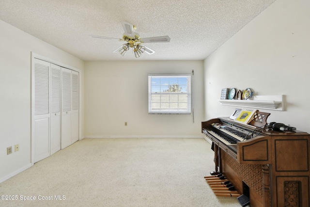 540 S Brevard Ave Unit 427, Cocoa Beach, FL 32931 - living area featuring carpet floors, a ceiling fan, and a textured ceiling