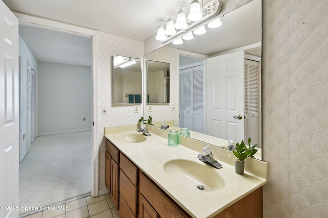 540 S Brevard Ave Unit 427, Cocoa Beach, FL 32931 - full bathroom with wallpapered walls, double vanity, a closet, and tile patterned flooring