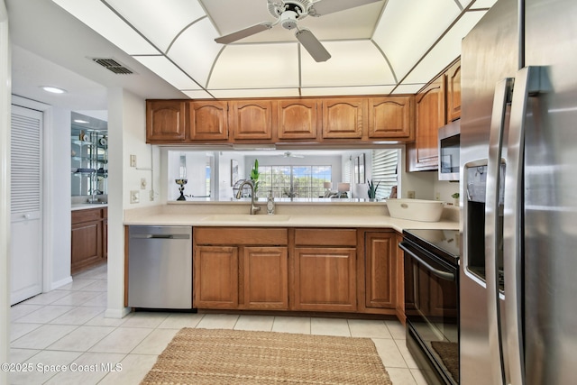 540 S Brevard Ave Unit 427, Cocoa Beach, FL 32931 - kitchen featuring stainless steel appliances, ceiling fan, light tile patterned flooring, and brown cabinets