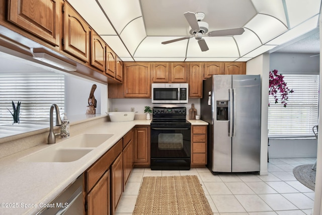 540 S Brevard Ave Unit 427, Cocoa Beach, FL 32931 - kitchen with stainless steel appliances, brown cabinets, ceiling fan, light countertops, and light tile patterned floors