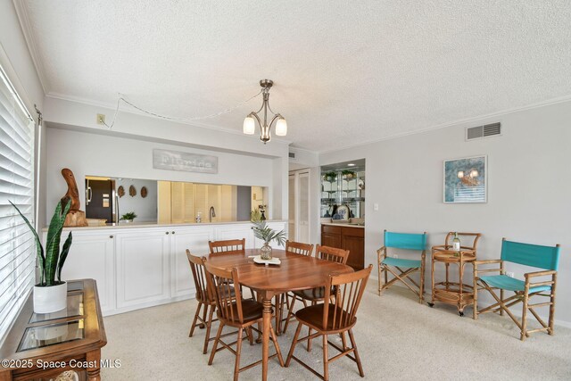540 S Brevard Ave Unit 427, Cocoa Beach, FL 32931 - dining area featuring a textured ceiling, ornamental molding, and light carpet