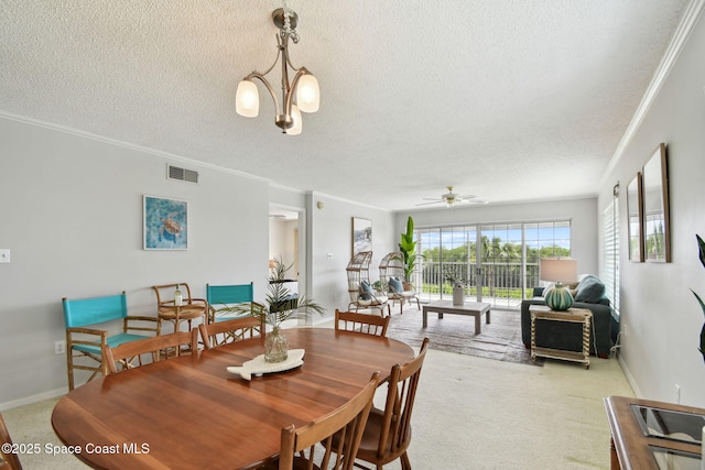 540 S Brevard Ave Unit 427, Cocoa Beach, FL 32931 - carpeted dining room featuring a textured ceiling, ornamental molding, and a ceiling fan