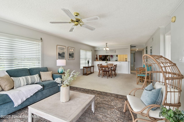 540 S Brevard Ave Unit 427, Cocoa Beach, FL 32931 - carpeted living area featuring a textured ceiling, ceiling fan, and a chandelier