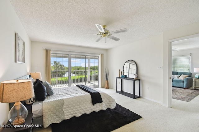 540 S Brevard Ave Unit 427, Cocoa Beach, FL 32931 - bedroom featuring access to outside, carpet flooring, a textured ceiling, and a ceiling fan