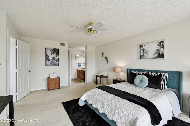 540 S Brevard Ave Unit 427, Cocoa Beach, FL 32931 - bedroom featuring light colored carpet, a textured ceiling, ceiling fan, and connected bathroom