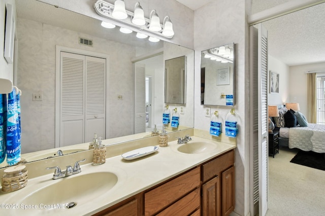 540 S Brevard Ave Unit 427, Cocoa Beach, FL 32931 - full bath with a closet, ensuite bathroom, double vanity, and a textured ceiling