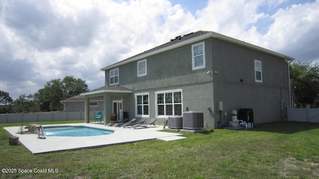 112 Broyles Dr SE, Palm Bay, FL 32909 - rear view of house with a patio, stucco siding, central AC unit, a fenced backyard, and a yard