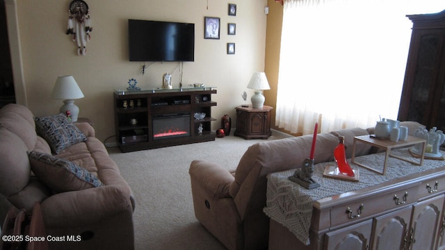 112 Broyles Dr SE, Palm Bay, FL 32909 - carpeted living room featuring a glass covered fireplace