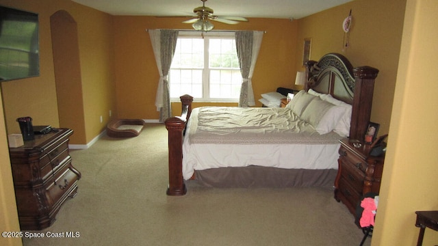 112 Broyles Dr SE, Palm Bay, FL 32909 - bedroom with arched walkways, baseboards, a ceiling fan, and carpet floors