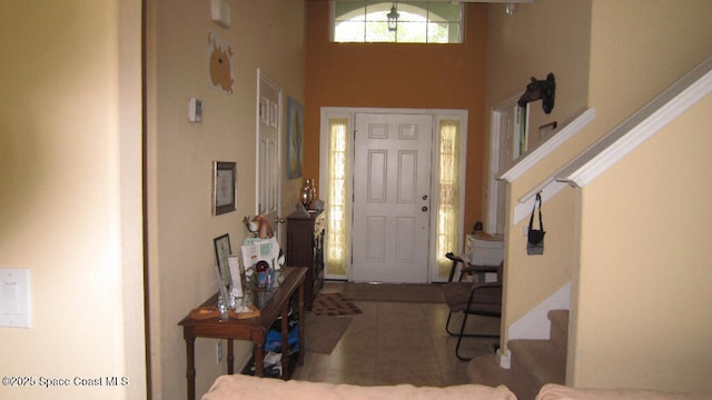 112 Broyles Dr SE, Palm Bay, FL 32909 - tiled entryway with a towering ceiling and stairs
