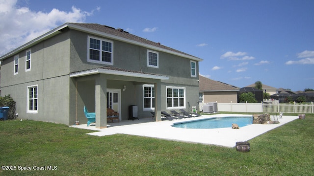 112 Broyles Dr SE, Palm Bay, FL 32909 - rear view of property featuring a patio, stucco siding, a fenced backyard, and a lawn
