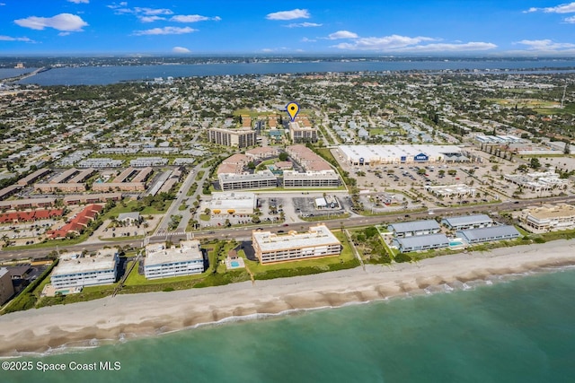 aerial view with a water view and a beach view