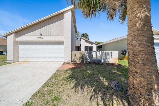 1730 Bluebird Ct, Melbourne, FL 32935 - view of side of property featuring concrete driveway, fence, a garage, and stucco siding