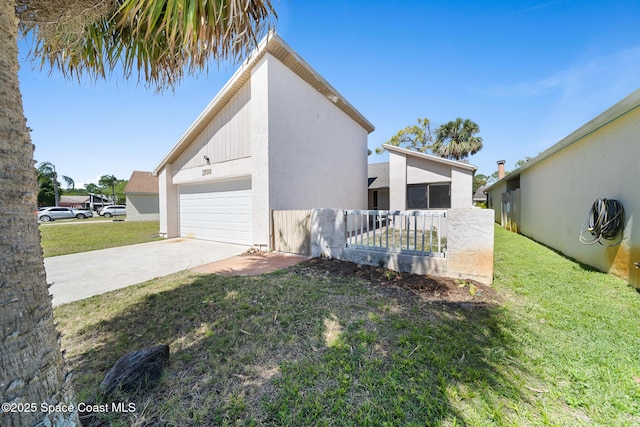 1730 Bluebird Ct, Melbourne, FL 32935 - view of side of home with concrete driveway, stucco siding, an attached garage, a yard, and fence