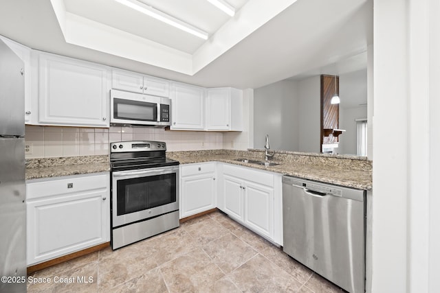 1730 Bluebird Ct, Melbourne, FL 32935 - kitchen featuring white cabinets, a tray ceiling, decorative backsplash, stainless steel appliances, and a sink