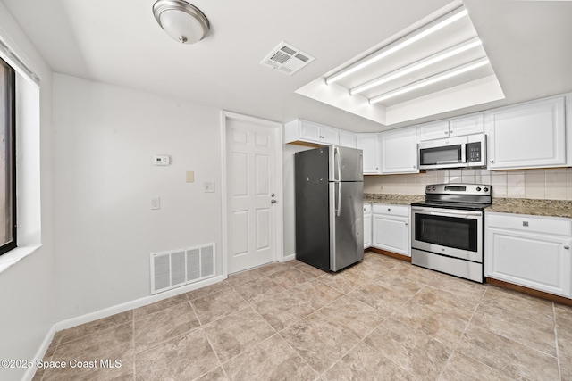 1730 Bluebird Ct, Melbourne, FL 32935 - kitchen with white cabinetry, visible vents, and stainless steel appliances