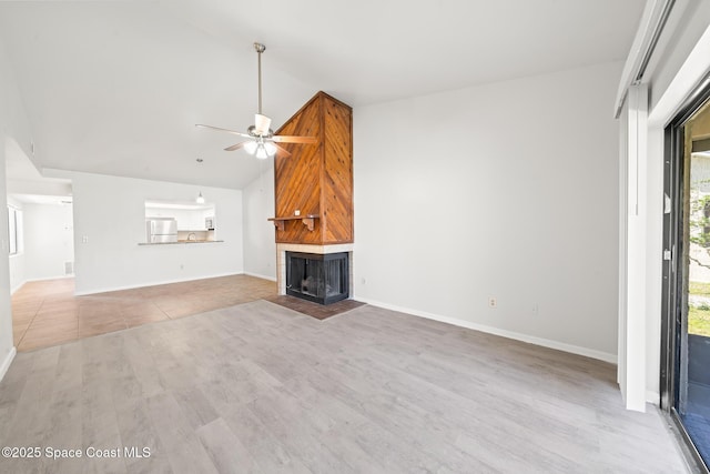 1730 Bluebird Ct, Melbourne, FL 32935 - unfurnished living room with ceiling fan, a fireplace, high vaulted ceiling, wood finished floors, and baseboards