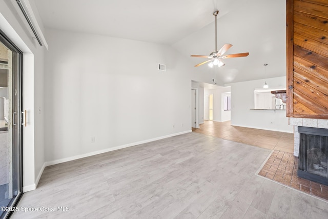 1730 Bluebird Ct, Melbourne, FL 32935 - unfurnished living room with visible vents, baseboards, ceiling fan, wood finished floors, and high vaulted ceiling