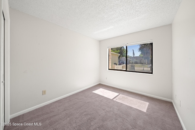 1730 Bluebird Ct, Melbourne, FL 32935 - carpeted empty room with a textured ceiling and baseboards