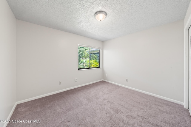 1730 Bluebird Ct, Melbourne, FL 32935 - unfurnished room featuring a textured ceiling, baseboards, and carpet floors