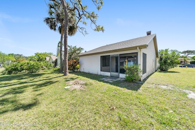1730 Bluebird Ct, Melbourne, FL 32935 - rear view of house with a yard, stucco siding, and a sunroom