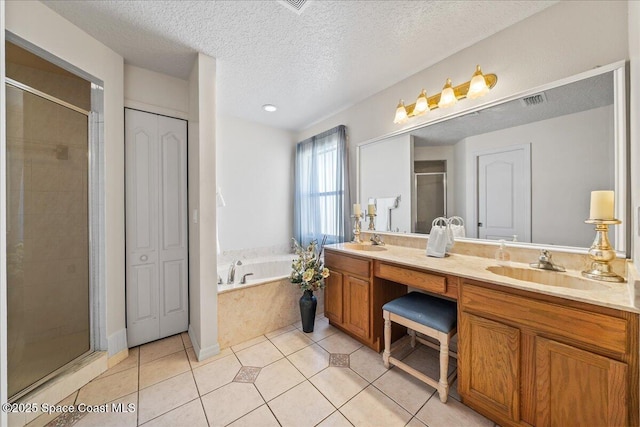 full bathroom with a shower stall, double vanity, a bath, and a sink