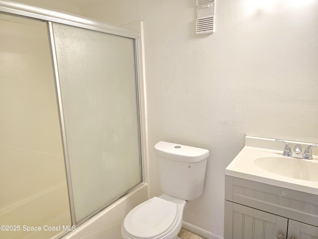 120 San Juan Cir, Melbourne, FL 32935 - bathroom with visible vents, toilet, combined bath / shower with glass door, baseboards, and vanity
