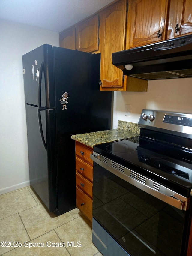 120 San Juan Cir, Melbourne, FL 32935 - kitchen with light tile patterned floors, brown cabinetry, freestanding refrigerator, electric stove, and under cabinet range hood