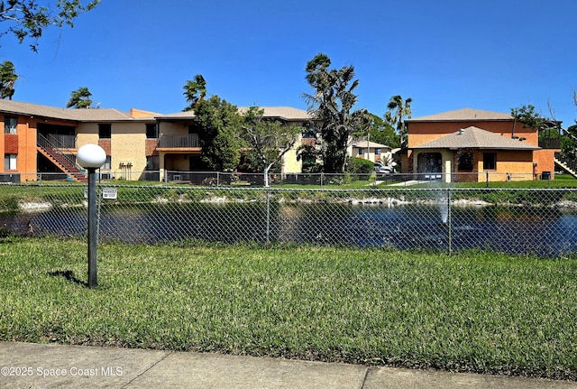 120 San Juan Cir, Melbourne, FL 32935 - exterior space featuring stucco siding, a front lawn, and fence
