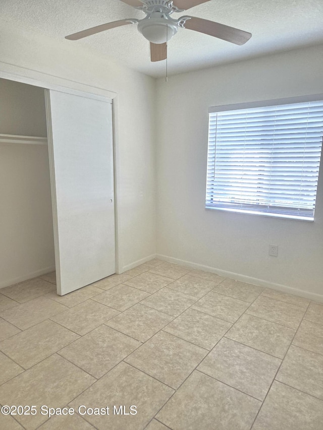 120 San Juan Cir, Melbourne, FL 32935 - unfurnished bedroom with ceiling fan, baseboards, a closet, and a textured ceiling