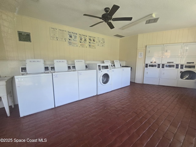 120 San Juan Cir, Melbourne, FL 32935 - common laundry area featuring visible vents, brick floor, ceiling fan, stacked washer and clothes dryer, and washing machine and dryer