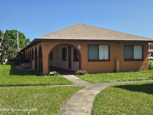 120 San Juan Cir, Melbourne, FL 32935 - view of front of property featuring stucco siding, a front yard, and roof with shingles