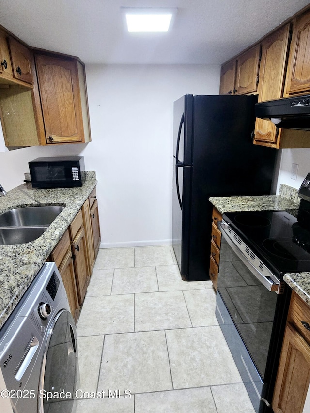 120 San Juan Cir, Melbourne, FL 32935 - kitchen featuring brown cabinets, black appliances, under cabinet range hood, a sink, and washer / dryer